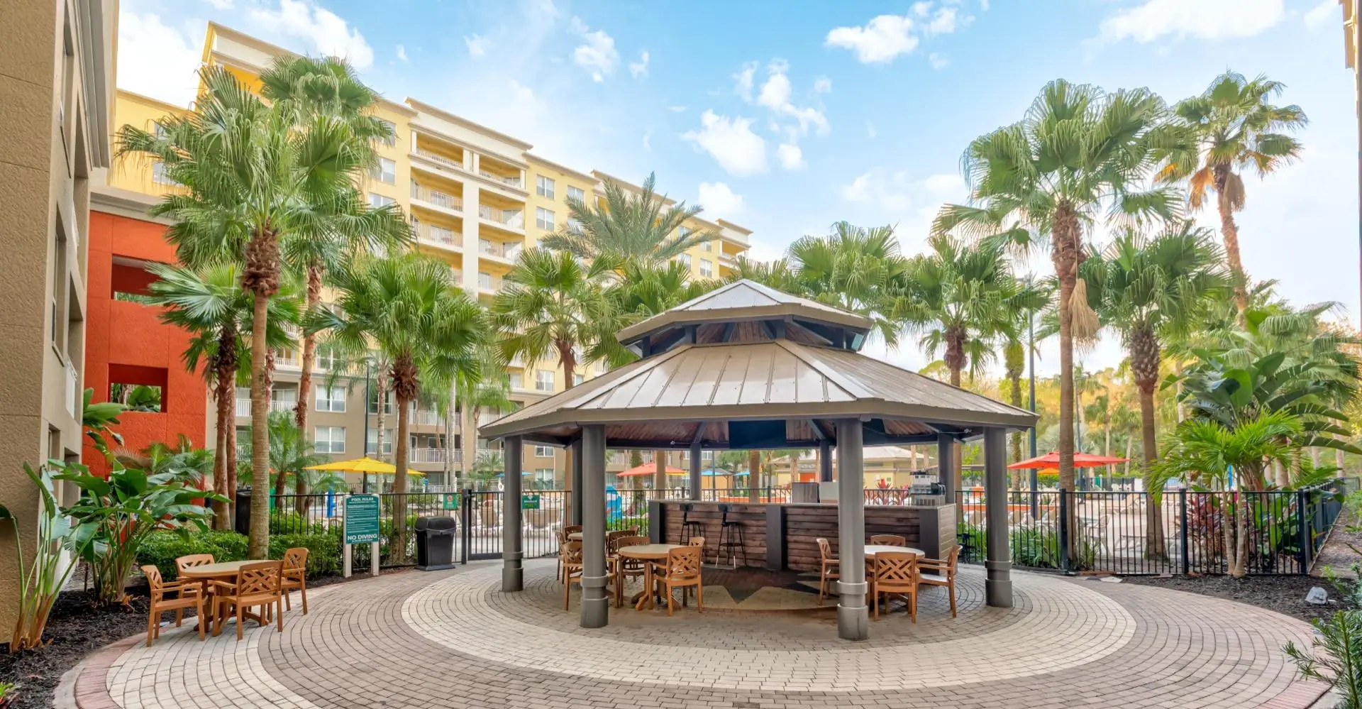 Parkway Orlando resort exterior with palm trees and pool area