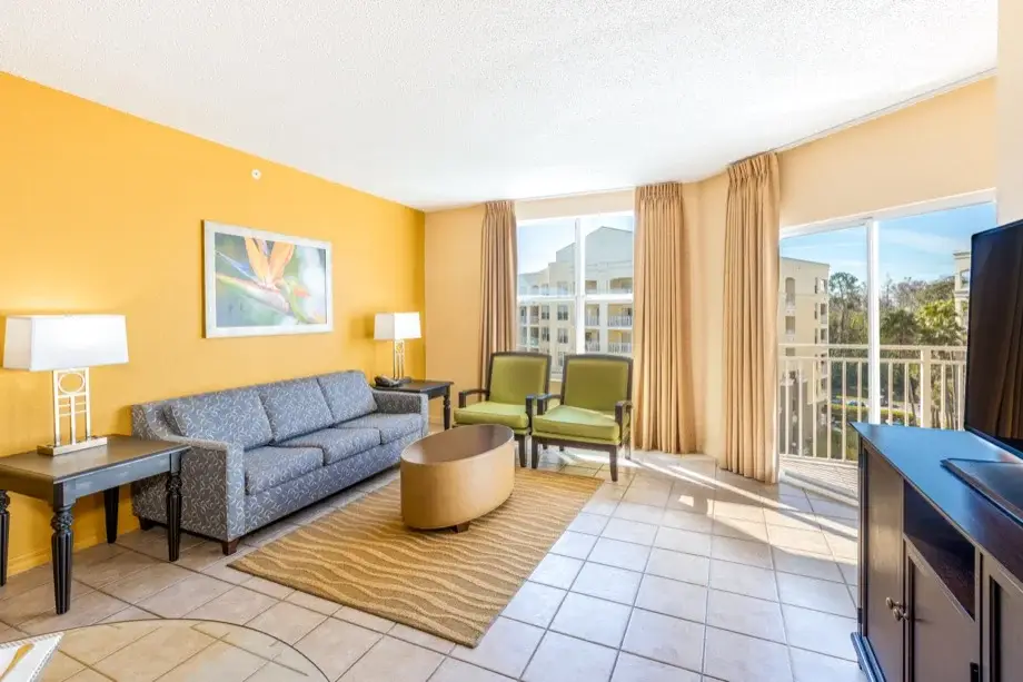 Spacious living room with separate sleeping area and balcony access