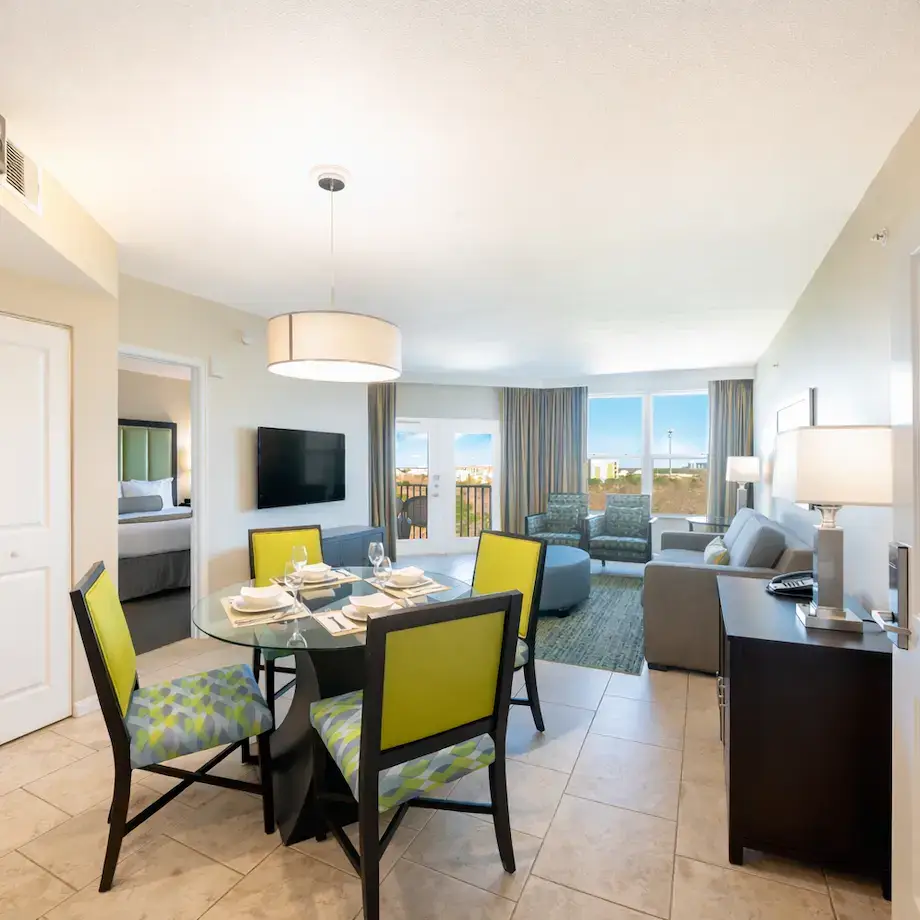 Spacious suite with dining area, living room, and balcony view