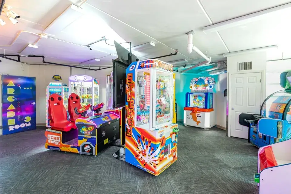 Arcade game room with claw machines and arcade cabinets