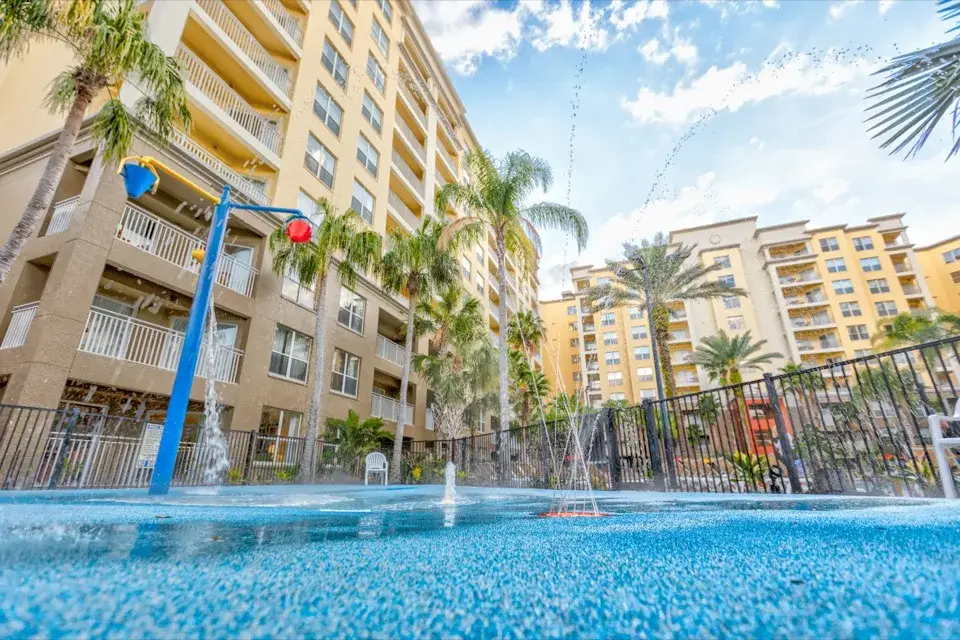 Splash pad water features and fountains between resort buildings