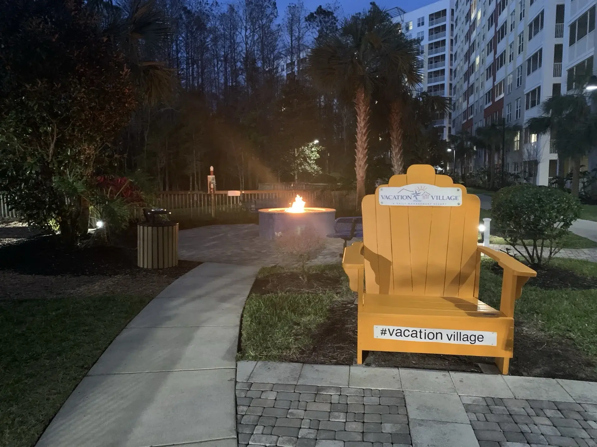 Golden Adirondack chair and cozy fire pit to set the scene at Vacation Village