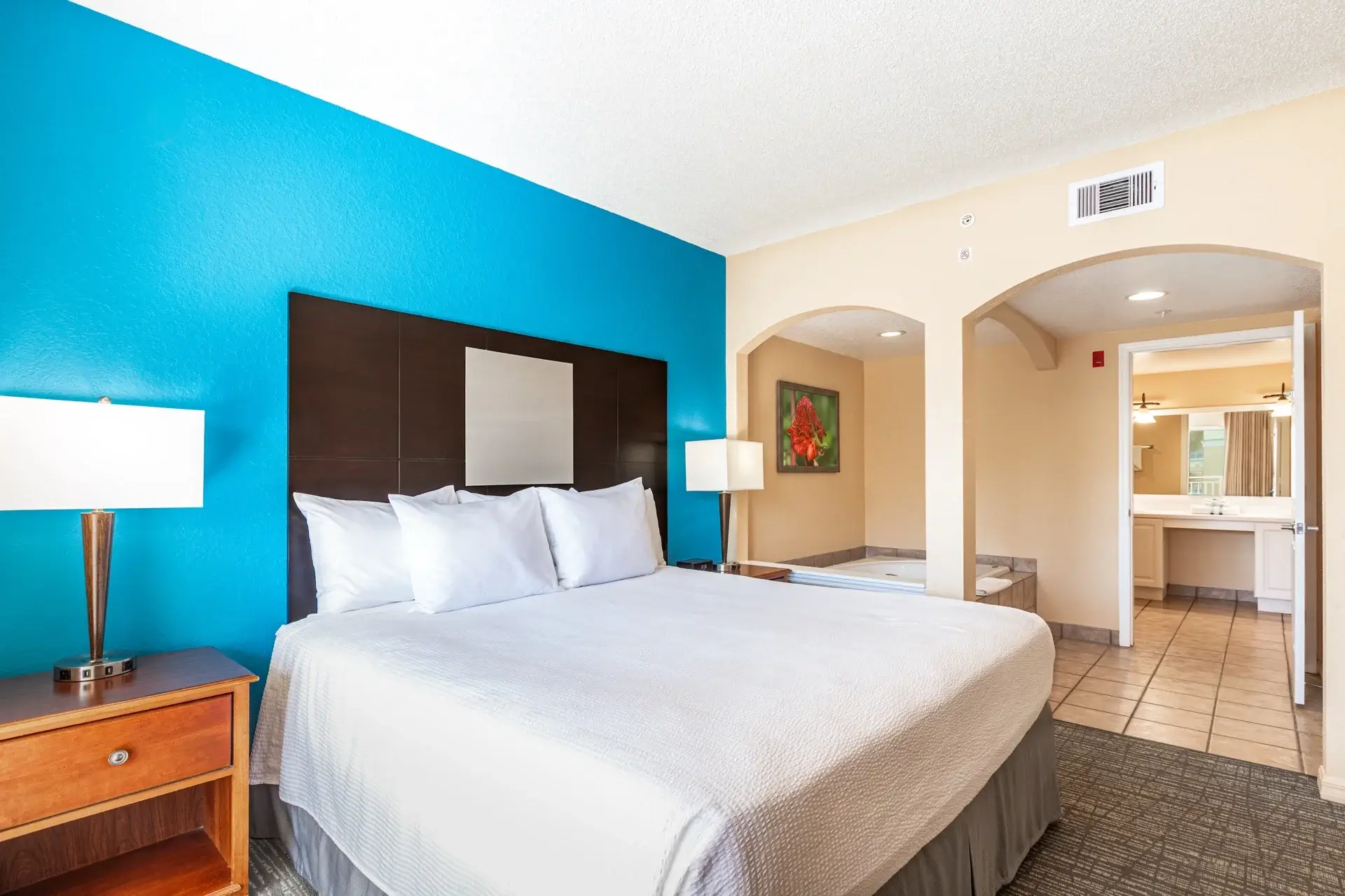 A Suite primary bedroom with adjoining bathroom