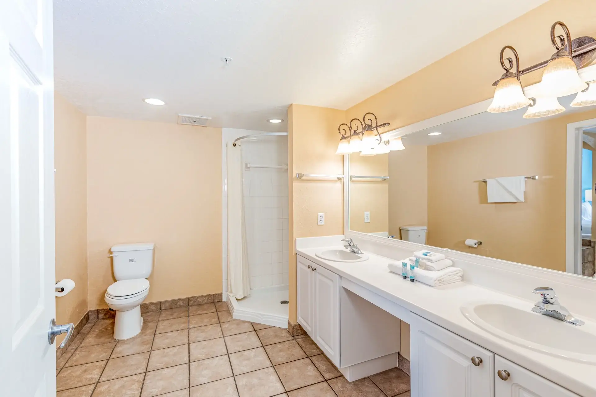 A Suite primary bathroom with double sink vanity and walk-in shower