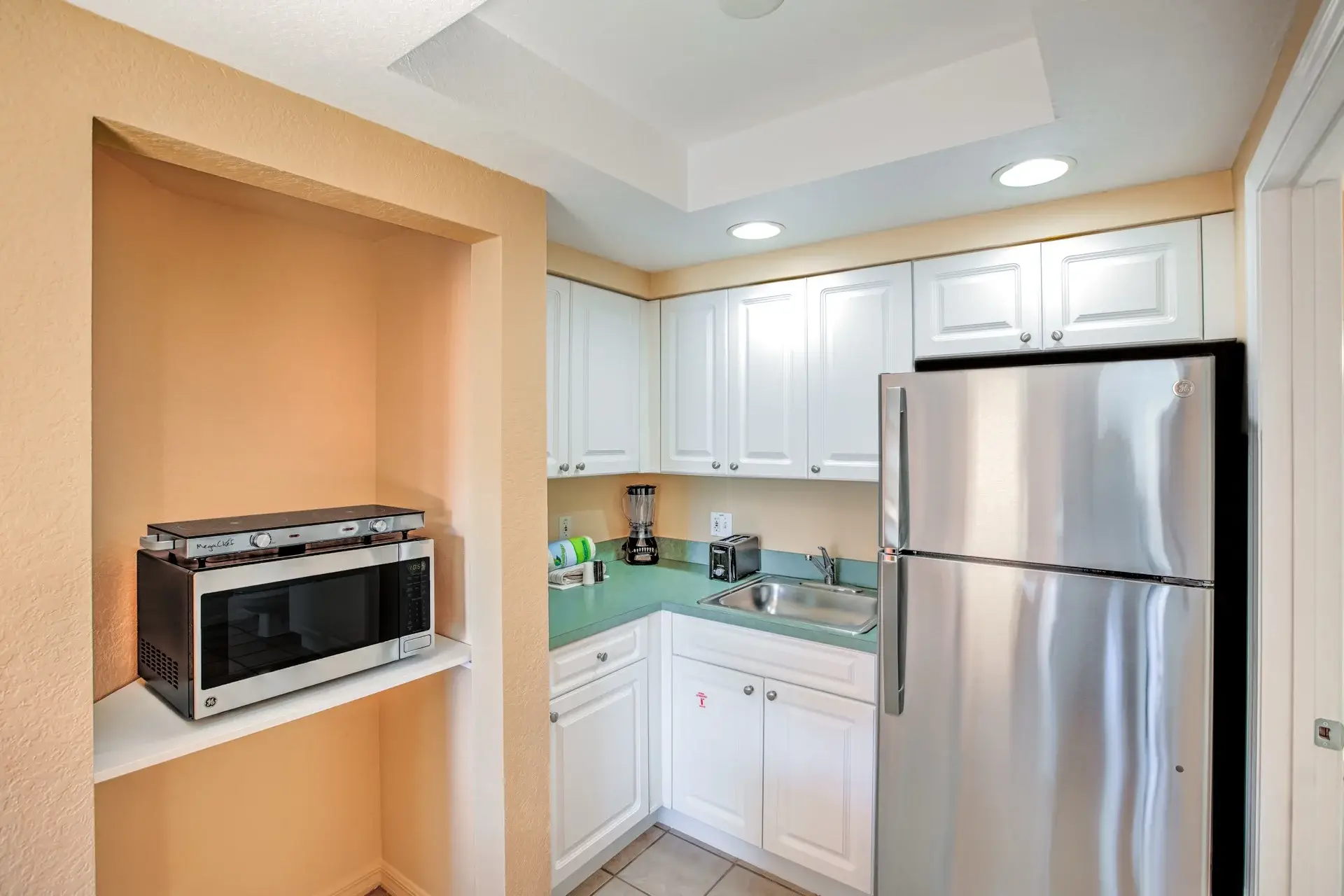 B Suite kitchenette with full-size refrigerator, microwave oven, and two-burner hot plate