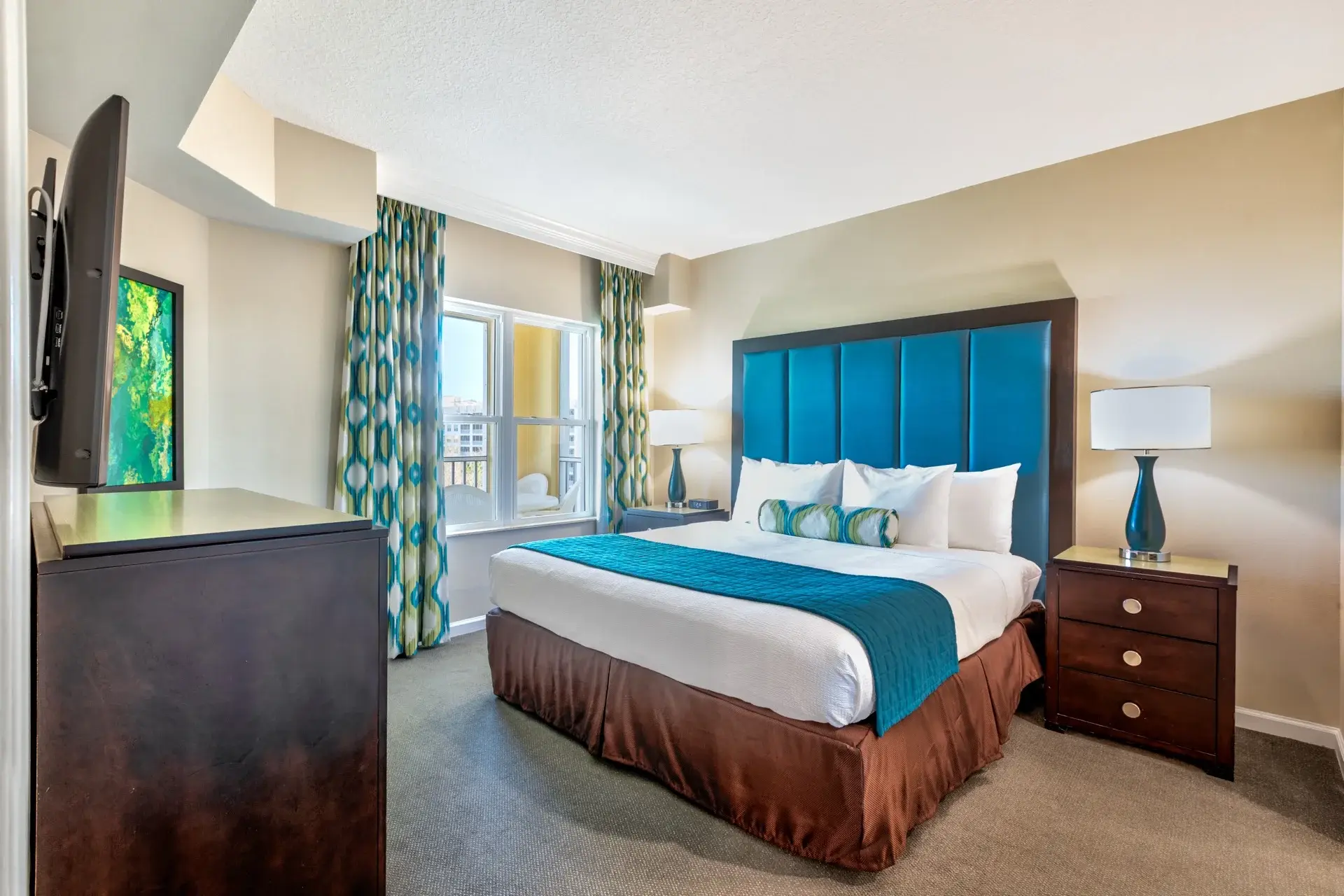 A Suite primary bedroom with a king-size bed