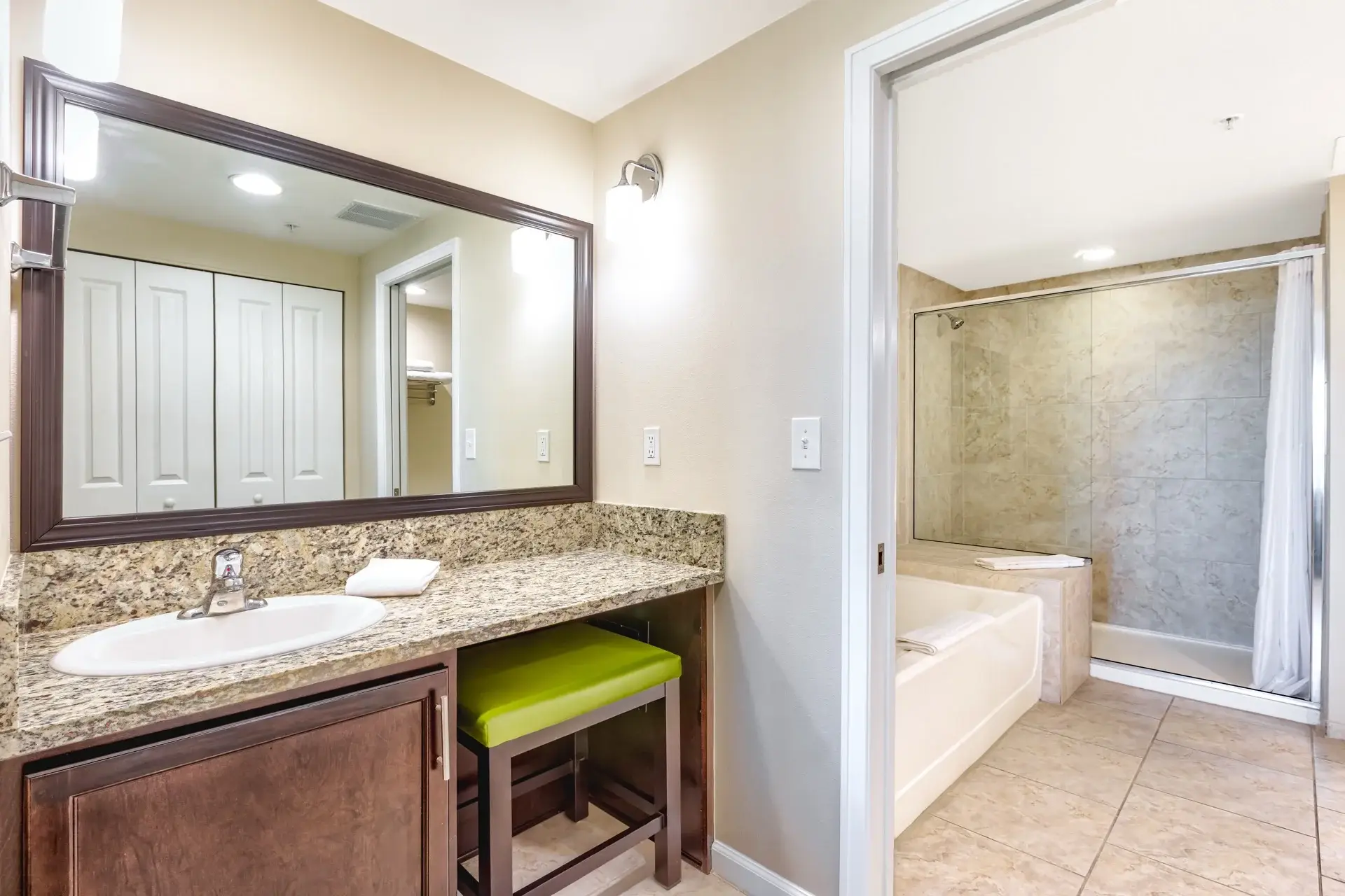 A Suite with a separate vanity area and adjoining bathroom