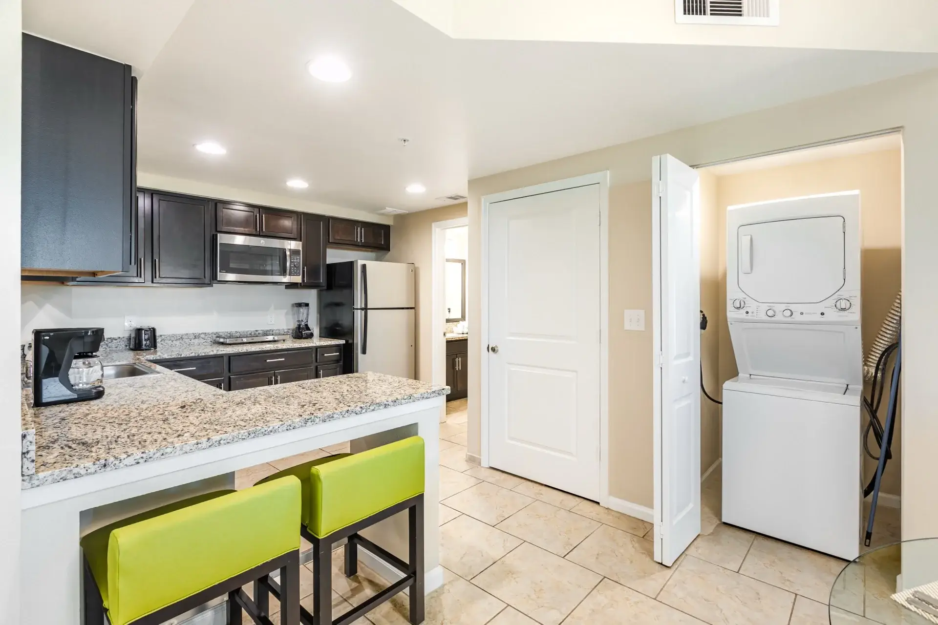 C Suite kitchenette with dishwasher and in-suite washer and dryer